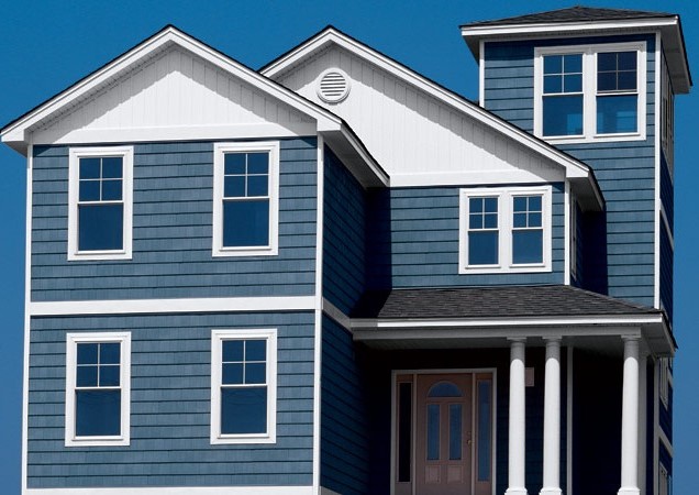 Modern two-story blue and white residential house with covered porch and white trim